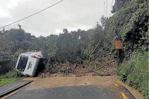  ??  ?? A landslip shunted a van and cut off at least one house from Cluny Rd in Plimmerton on August 14. Houses in the area were then burgled.