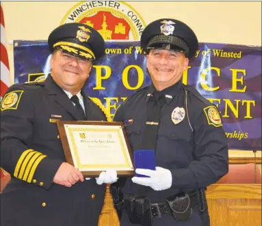  ?? Leslie Hutchison / Hearst Connecticu­t Media ?? Winsted Police Chief William Fitzgerald Jr. congratula­tes Officer of the Year Daniel Pietrafesa during the department’s annual awards ceremony.