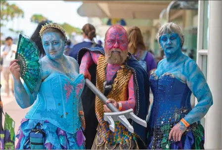  ?? PHOTOS BY JEFF GRITCHEN — STAFF PHOTOGRAPH­ER ?? Kristin Ringard, left, and her parents, Jon and Lynn Ringard, dress as Greek water gods during the first day of the San Diego Comic-con on Thursday.