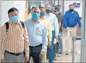  ??  ?? People wait in line to register during the administer­ing of the Covaxin vaccine in New Delhi.