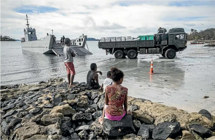  ?? NZ DEFENCE FORCE ?? A Medium Heavy Operationa­l Vehicle, loaded with food aid and shelter boxes, is driven off a landing craft on Vanua Balavu Island in Fiji, after tropical cyclone Winston in early 2016.