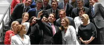  ?? PHOTO: DAN PELED ?? NEW CABINET: State Developmen­t Minister Cameron Dick (centre) takes a selfie with fellow ministers after a swearing in ceremony at Government House in Brisbane.