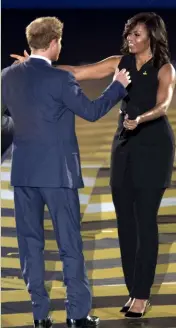  ??  ?? Michelle Obama greets her “Prince Charming” at the opening of the Invictus Games in May.