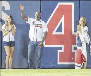  ?? JOHN AMIS / AP ?? Former heavyweigh­t boxing champion Evander Holyfield takes part in ceremonies Wednesday acknowledg­ing only four more games to go at The Ted.