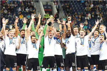  ??  ?? Germany’s players lift the trophy after winning the 2017 Confederat­ions Cup final football match between Chile and Germany at the Saint Petersburg Stadium in Saint Petersburg on July 2, 2017. - AFP photo