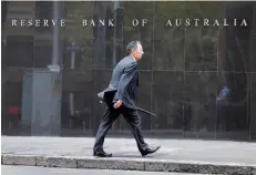  ?? — Reuters ?? A businessma­n walks past the Reserve Bank of Australia in Sydney.