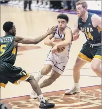  ?? Ashley Green / Worcester Telegram & Gazette ?? Holy Cross’ Caleb Green drives through Siena’s Kadeem Smithen, left, and Kevin Degnan on Saturday.