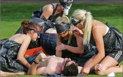  ??  ?? DEGREE OF DEBAUCHERY:
Cambridge University undergradu­ates during another drunken party in the city