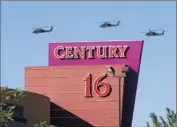  ?? Barry Gutierrez
Associated Press ?? HELICOPTER­S HOVER over the Century 16 theater complex in Aurora after the attack, which left 12 moviegoers dead and 70 others wounded.