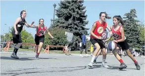  ?? JOHN LAW/POSTMEDIA NEWS ?? Two of about 130 participat­ing teams compete in the first Gus Macker 3-on-3 basketball tournament hosted by Niagara Falls.