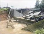  ?? JOHN MONE — ASSOCIATED PRESS ?? Waters rush into a large sinkhole on Highway FM 762in Rosenberg, Texas, near Houston on Sunday.
