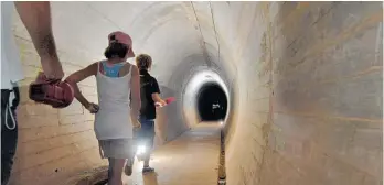  ?? Photo / Michael Craig ?? Visitors make their way through the tunnels at the Stony Batter gun emplacemen­t.