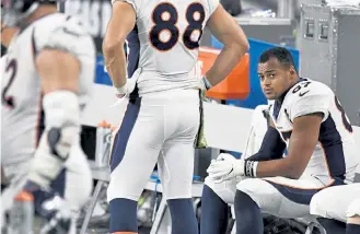  ??  ?? Broncos tight end Noah Fant sits on the bench as the clock winds down in their game against the Las Vegas Raiders on Sunday. Denver lost 37- 12.