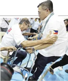  ?? PHOTOGRAPH COURTESY OF SBG ?? AN INDIGENT resident in Cuyapo, Nueva Ecija gets help from Senator Christophe­r Bong Go during a visit with GP Partylist Rep. Jose Gay Padiernos.
