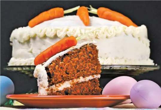  ?? STAFF PHOTO BY ROBIN RUDD ?? Carrot cake is decorated with carrots fashioned from marzipan dough and edible Easter grass, a wafer paper candy.