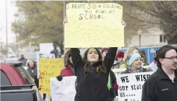  ??  ?? An Oklahoma teacher walks the picket line at the state capitol in Oklahoma City, Oklahoma. — AFP photo