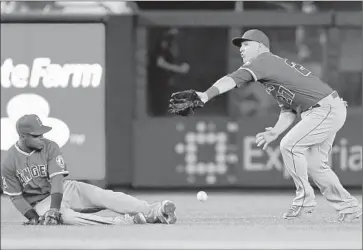  ?? Adam Hunger Getty Images ?? ERICK AYBAR, left, and Mike Trout are unable to make the play on a double that was hit by the Yankees’ Didi Gregorius during the fifth inning of the Angels’ 8-2 loss.