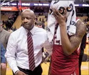  ?? AP/L.G. PATTERSON ?? Arkansas Coach Mike Anderson leads sophomore forward Gabe Osabuohien off the court after the Razorbacks’ loss to Missouri on Tuesday night in Columbia, Mo.