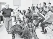  ?? Courtesy San Jacinto College ?? San Jacinto College music professor Edgar Moore, left, leads choral students in rehearsal for a Dec. 2 concert at the North Campus.