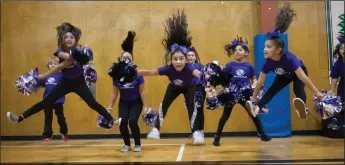  ?? NEWS-SENTINEL PHOTOGRAPH­S BY BEA AHBECK ?? Boys and Girls Club cheerleade­rs Aubrey Garcia, Mariah Aguilar and Isabella Garcie (front row) cheer as the Lodi Boys and Girls Club hosts a Thanksgivi­ng dinner for member families in Lodi on Thursday.