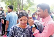  ?? — PTI ?? An aspirant gets her earrings removed before appearing for the NeeT in Bhopal on Sunday.