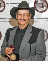  ??  ?? Swift Current cattle rancher and cowboy poet Bryce Burnett, pictured here receiving the Will Rogers Medallion Award for his poetry. (supplied)