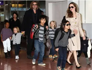  ??  ?? Brad and Angelina together with the six children at airport on visit to Japan in 2011