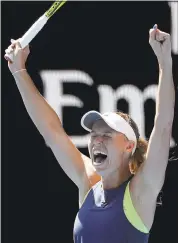  ?? DITA ALANGKARA — THE ASSOCIATED PRESS ?? Caroline Wozniacki celebrates after defeating Elise Mertens in straight sets in their Australian Open semifinal match.