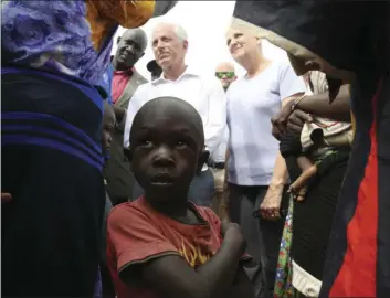  ?? PHOTO ?? A child looks up while Senator Bob Corker (center left) speaks to recent refugees from South Sudan at a registrati­on center Friday in Bidi Bidi, Uganda. AP