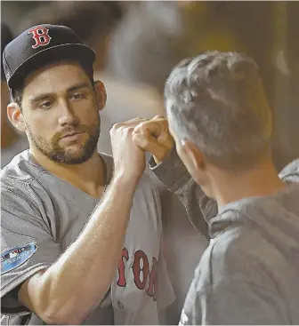  ?? STAFF PHOTO BY CHRISTOPHE­R EVANS ?? QUALIFY EFFORT: Nathan Eovaldi gets congratula­tions in the Red Sox dugout after giving up just two runs and six hits over six innings in yesterday’s 8-2 victory against the Astros in Game 3 of the AL Championsh­ip Series.