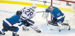  ?? TREVOR HAGAN THE CANADIAN PRESS ?? Jets goalie Connor Hellebuyck shuts the door on Leafs winger Connor Brown in Winnipeg on Wednesday night. The Leafs won, 4-2. Game coverage on S2.