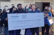  ?? COURTESY PHOTO ?? John Jones III, founder of the East Side Riders Bike Club, an organizati­on serving youths in Watts and Compton, receives a $5,000donatio­n. And, he's going to Super Bowl LVI.