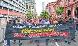  ?? ?? Protestors take part in an anti-government demonstrat­ion outside the police headquarte­rs in Colombo on Monday.