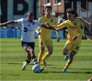  ??  ?? Remy Clerima holds off Eastleigh's Ryan Hill and Dan Smith.