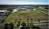  ?? JIM NOELKER/ STAFF ?? The Dayton Regional STEM School plans to buy more than 9 acres from the city of Kettering in Miami Valley Research Park to build a new elementary school. The existing STEM school building is at the left edge of the photo, with Woodman Drive at the bottom and the Research Park in the background.