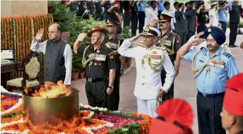  ?? — PTI ?? Defence minister Arun Jaitley, Army Chief Gen. Bipin Singh Rawat, Chief of Air Staff Air Chief Marshal B.S. Dhanoa and Navy Chief Admiral Sunil Lanba pay homage at Amar Jawan Jyoti on the occasion of Kargil Vijay Diwas in New Delhi on Wednesday.