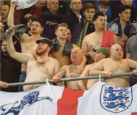  ??  ?? England fans look disappoint­ed after their team’s defeat to Germany in the internatio­nal friendly in Dortmund on Wednesday.