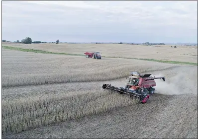  ?? Bloomberg file photo ?? Combines harvest soybeans in September near Tiskilwa, Ill. Two shiploads of U.S. soybeans left for China in the past week, despite retaliator­y tariffs targeting the crop that China imposed in July.