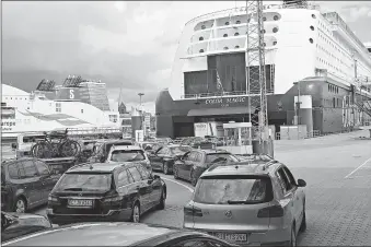  ?? [CARSTEN REHDER/DPA VIA THE ASSOCIATED PRESS] ?? Cars wait Wednesday in front of the `MS Color Magic' in Kiel, Germany.