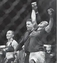  ?? Kyusung Gong / Associated Press ?? Amanda Nunes, right, celebrates her victory over Cris Justino in the women’s featherwei­ght title bout at UFC 232 in Inglewood, Calif., on Saturday night.