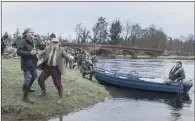  ??  ?? WATER WORK: Dougie MacLean and Provost of Perth and Kinross Dennis Melloy carry out the traditiona­l blessing of the River Tay.