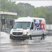  ?? / Kevin Myrick ?? A FedEx delivery van plowed through rising waters on East Avenue heading westward during an afternoon downpour on July 31.