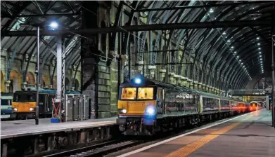  ?? EIKI SEKINE. ?? Caledonian Sleeper 92010 (foreground) and 92033 stand at London King’s Cross on August 27, with the 2119 to Inverness (the latter is hauling the 2208 to Aberdeen/Fort William). The trains were diverted from Euston because that was closed in connection...