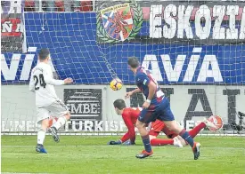  ??  ?? Eibar’s Sergi Enrich, right, scores his team’s second goal against Real Madrid.