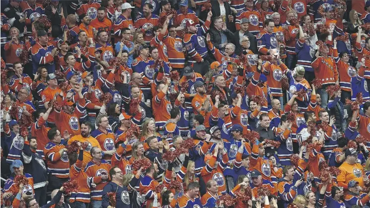  ?? ED KAISER ?? A crush of orange-clad fans cheer the Oilers’ first goal against the San Jose Sharks in the first game of the playoffs at Rogers Place on Wednesday. A new poll confirms the city has caught Oilers fever, with more than half of all fans believing the...