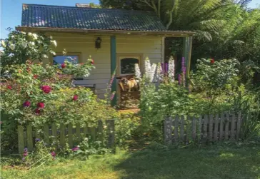  ??  ?? CLOCKWISE FROM MAIN A place to store tools and relax; Dora on the verandah of the ‘Old School House’ in Jennifer Stackhouse’s garden; Tino Carnvale loves his rustic shed.