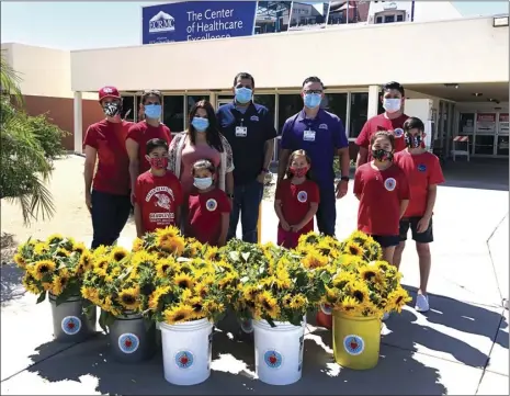  ?? PHOTO MARC WALTERS ?? Sacred Heart School delivers over 300 fresh cut sunflowers to thank El Centro Regional Medical Center’s first responders.