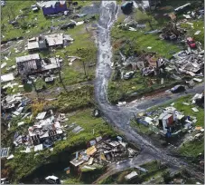  ?? "1 1)050 ?? In this Sept. 28 photo, destroyed communitie­s are seen in the aftermath of Hurricane Maria in Toa Alta, Puerto Rico.