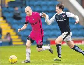  ??  ?? Willo Flood holds off Chris Johnston at Stark’s Park.