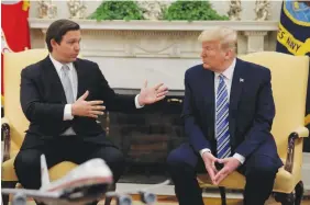  ?? (Carlos Barria/Reuters) ?? THEN-US president Donald Trump listens to Florida Governor Ron DeSantis speak during a meeting at the White House in 2020.